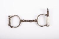 HANDCUFFS: A pair of original 19th century Hiatt Best Warranted Wrought handcuffs with key