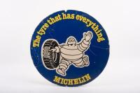 MICHELIN: A double sided round Michelin cardboard advertising sign featuring waving Bibendum&nbsp;to either side 'The tyre that has everything - Michelin' 36cm in diameter&nbsp;