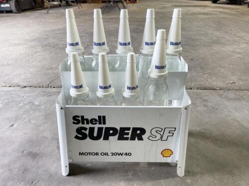 OIL BOTTLE RACK: A reproduction Shell Super SF motor oil rack with a collection of 6 one-litre and 3 500ml bottles, along with Valvoline branded plastic tops and caps [Location: Sydney]