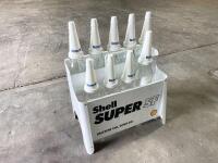 OIL BOTTLE RACK: A reproduction Shell Super SF motor oil rack with a collection of 6 one-litre and 3 500ml bottles, along with Valvoline branded plastic tops and caps [Location: Sydney] - 2