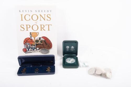 SPORTING: A collection of sporting-related items, including Sir Don Bradman Perth Mint commemorative coin, a collection of Classic Ashes medal collection coins with various cricketers' names, sporting book and Sydney 2000 Olympics pin set