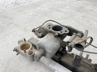 JAGUAR: A Jaguar Mark II inlet manifold with water rail and carburettors. [Location: Sydney] - 6