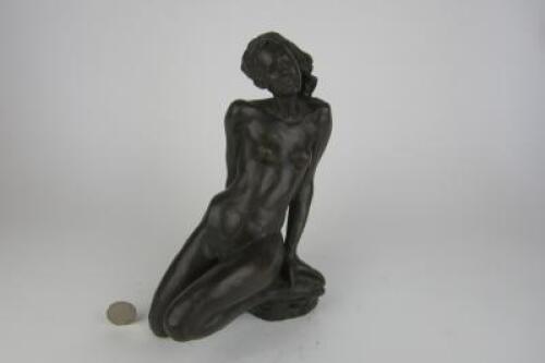 EVE: A plaster figure of Eve reclining with apple and serpent