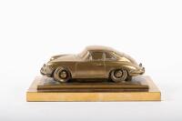 PORSCHE: A fine and rare heavy brass sculpture of Porsche 356 on a double plinth base, with etched artist signature '2001 Martin Russell', 12cm high, 28.5cm long, 16cm wide overall