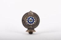 R.A.C.V.: A Royal Automobile Club of Victoria car grille badge fixed to bracket, has member number 13447&nbsp;stamped into the base, c1930s - 1940s, 10 cm diameter