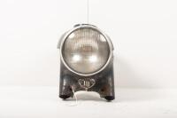 TRIUMPH: A post-war Triumph 'Nacelle' headlight surround and seven inch Lucas lens headlight