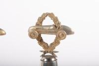 TROPHIES: Three trophies, all not inscribed, all have wreath and racing car finials with round bakelite bases - 4