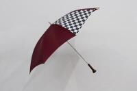 PORSCHE UMBRELLA: A circa 1980s Porsche umbrella with Porsche emblem fixed to wooden handle, maroon in colour with chequered flag detail