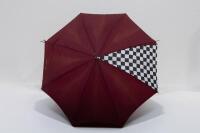 PORSCHE UMBRELLA: A circa 1980s Porsche umbrella with Porsche emblem fixed to wooden handle, maroon in colour with chequered flag detail - 2