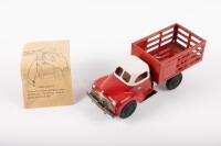 WALT REACH: A c1950s Courtland Stake Bed Truck tin plate toy by Walt Reach Toys USA, 21cm long