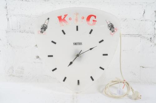 KLG: A c1960s K.L.G spark plugs wall clock by Smiths, fading seen to red lettering, right hand side spark plug missing top, 44cm high, 43.5cm wide