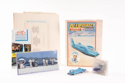 82 · BLUEBIRD: A Corgi Toys No.153 Proteus Campbell Bluebird model, with souvenir cake of salt from Lake Eyre South Australia, along with a selection of commemorative paraphernalia relating to the Bluebird and land speed record vehicles