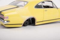 HOLDEN: A Trax 1:24 Holden Monaro&nbsp;GTS (TX-031) in yellow&nbsp;with black G.T stripes, black seats, opening features, engine detail, steerable wheels, in original protective box - 4