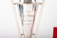 TROPHY: A large two-handled trophy on round bakelite base awarded to Alan Hamilton at the 1976 Daily Mirror Sports Sedan Classic, comes with framed & glazed photograph of Alan Hamilton holding said trophy whilst being kissed by two grid girls - 2