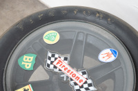 LOLA T70/SURFERS PARADISE/DON O'SULLIVAN: An original race used wheel mounted as a coffee table with glass top and applied stickers - 3