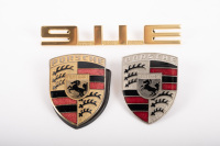 PORSCHE BADGES: Three Porsche badges, includes two Porsche bonnet crest badges and a Porsche 911E badge