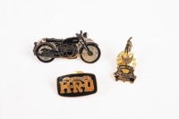 A group of three pins/badges related to Vincent