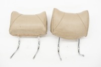 HEAD RESTS: Two tan coloured head rests, suitability unknown
