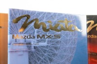 MAZDA: A set of two 'Miata - Mazda MX-5' hardcover books by Jack K. Yamaguchi and Jonathan Thompson, held within slip case - 3