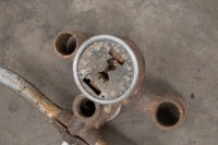 A handlebar, and top triple clamp with affixed 120 MPH speed, believed Royal Enfield - 2