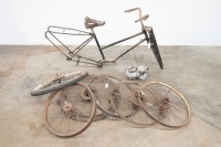 A collection of Autocycle parts including frame, forks, wheels