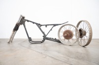 A motorcycle frame and two alloy rims believed to be CZ