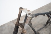 A motorcycle frame and two alloy rims believed to be CZ - 2