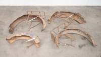 Four various rusty mudguards, two with luggage racks