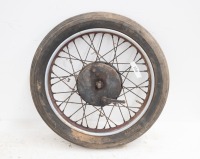 A 1950s 19" British front wheel, possibly BSA/Triumph, turns, with hub and brake plate