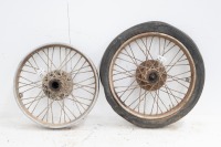 Two front wheels (19" & 20" with tyres) with finned brake drums, one with bearings - possible early Triumph Speed Twin