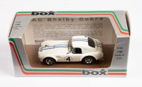 AC SHELBY COBRA: A 1:43 scale AC Shelby Cobra, the number #4 race car from the 1963 Le Mans 24 hour, with the driver combination of Hugas - Jopp