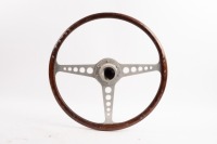 JAGUAR: A Jaguar E-Type steering wheel, three spoke, wooden rim, 42cm wide [Location: Melbourne] - 2