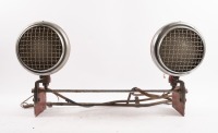 VAUXHALL: A pair of circa 1930s or 1940s Vauxhall headlamps fixed to custom built frame, with Vauxhall glass lenses and stone mesh covers, lens width 16cm [Location: Melbourne]