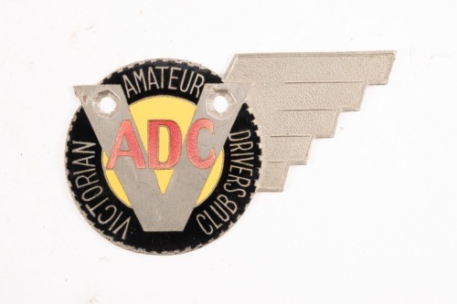 V.A.D.C: A Victorian Amateur Drivers Club badge, nickel plated and yellow enamel centre with red lettering, two mounting holes, 6.5cm high, 11cm wide [Location: Melbourne]