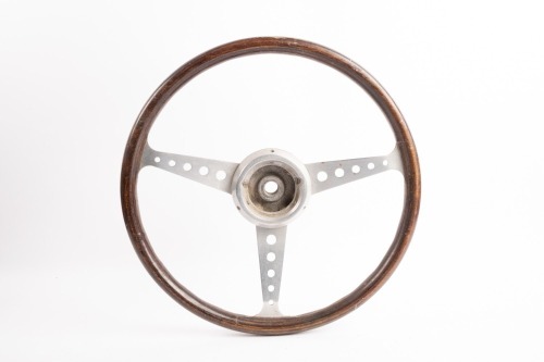 STEERING WHEEL: A three spoke wood rim steering wheel, 38cm wide [Location: Melbourne]
