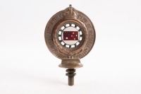 R.A.C.V: An early Royal Automobile Club of Victoria (RACV) member's hood ornament badge by Angus & Coote Ltd Sydney, member number '7158' engraved to base, 10cm wide, 16cm high overall [Location: Melbourne]