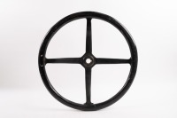 STEERING WHEEL: An early four spoke steering wheel, wooden rim, 43cm wide [Location: Melbourne]