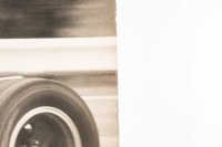 DENIS HULME: A large original black & white photograph by Lawrence Thomas of Dennis Hulme racing a BT19, signed by Dennis Hulme 'With Very Best Wishes - Dennis Hulme', 49cm high, 59cm wide - 3