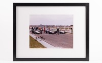 JACK BRABHAM: A colour photograph signed by Jack Brabham, features a circa late 1960s starting grid at Sandown, framed & glazed, image 20cm high, 24cm wide