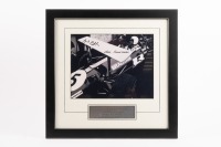 BT26A: A photograph featuring Sir Jack sitting in a BT26A in 1969 giving Ron Tauranac feedback, hand signed by Sir Jack and Ron Tauranac, framed and glazed, image 19cm high, 25cm wide