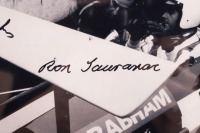 BT26A: A photograph featuring Sir Jack sitting in a BT26A in 1969 giving Ron Tauranac feedback, hand signed by Sir Jack and Ron Tauranac, framed and glazed, image 19cm high, 25cm wide - 4