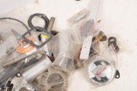 NORTON: A group of assorted new Norton parts, includes such things as tank badges, one cable, exhaust nut, ignition coil etc&nbsp; - 2