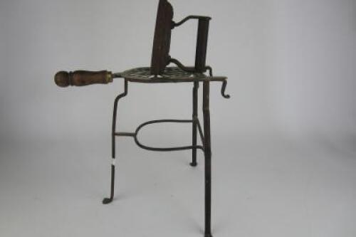 IRON: An antique cast iron and brass trivet