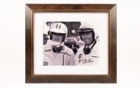 HULME: A framed black and white photograph featuring Denny Hulme and Jack Brabham, photograph hand signed by Brabham, framed and glazed, 35.5cm high, 40cm wide overall