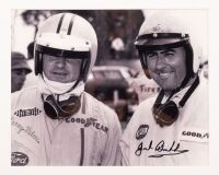 HULME: A framed black and white photograph featuring Denny Hulme and Jack Brabham, photograph hand signed by Brabham, framed and glazed, 35.5cm high, 40cm wide overall - 2