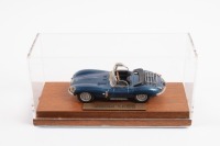 JAGUAR: A 1:43 scale Jaguar XKSS in blue with black interior, fixed to wooden base in perspex case