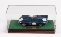 JAGUAR: A 1:43 scale Jaguar D-Type in blue presented fixed to wooden base in perspex case