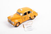 HOLDEN FJ: A 1:24th scale Trax Holden FJ special sedan model, this FJ model is finished in orange paintwork, bearing the Yellow Cab co livery, limited edition