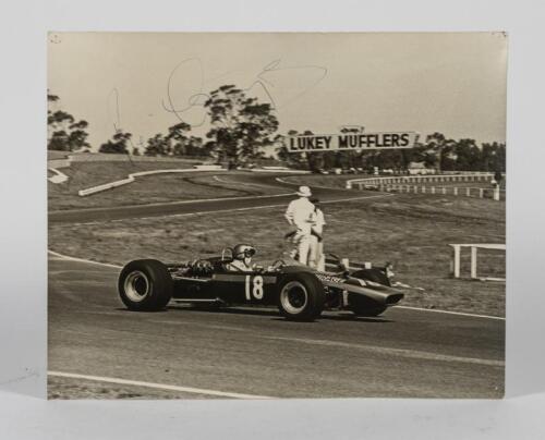 COURAGE: A 1968 period black and white photograph of Piers Courage racing at Sandown Raceway, Victoria. Signed by Piers Courage. Measures 38cm wide, 30.5 cm high