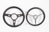 STEERING WHEELS: Two leather bound three spoke racing steering wheels
